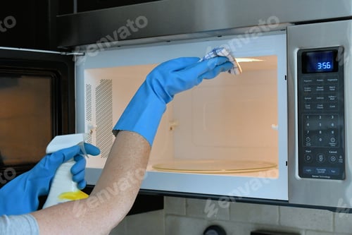 Preview: Doing housework chores by cleaning the microwave in the kitchen