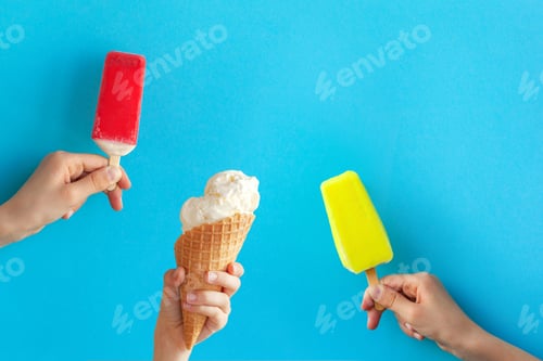 Preview: Child hands holding assorted ice cream on blue background.