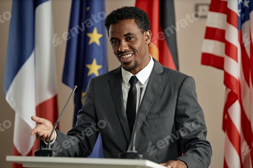 Preview: Young Adult Black Man Speaking at Podium during International Conference