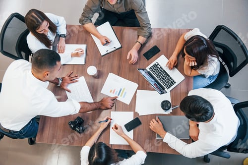 Preview: young business people that working together with documents and laptop in the modern office