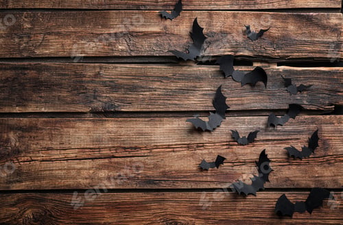 Preview: Paper bats on wooden background, flat lay with space for text. Halloween decor