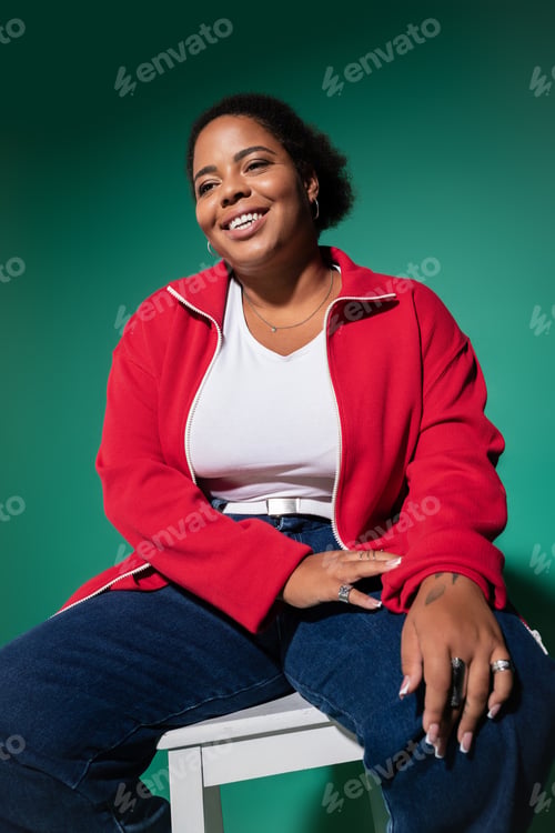 Preview: Plus size African American woman in stylish autumn fashion in studio setting
