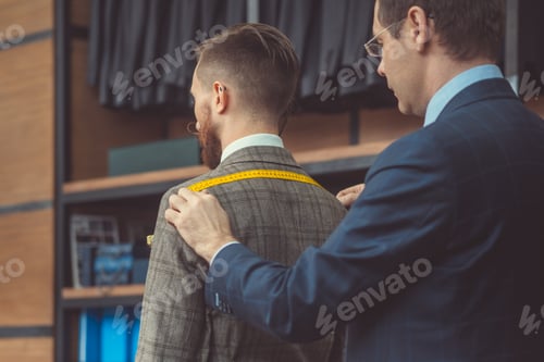Preview: Tailor Fitting Custom Suit for Client in Shop