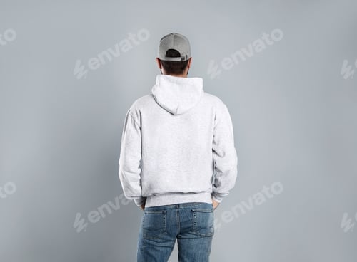 Preview: Young man in sweater on grey background. Mock up for design