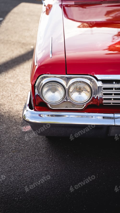 Preview: Vertical shot of vintage redcar lights and the hood. Aesthetic wallpaper for car lovers