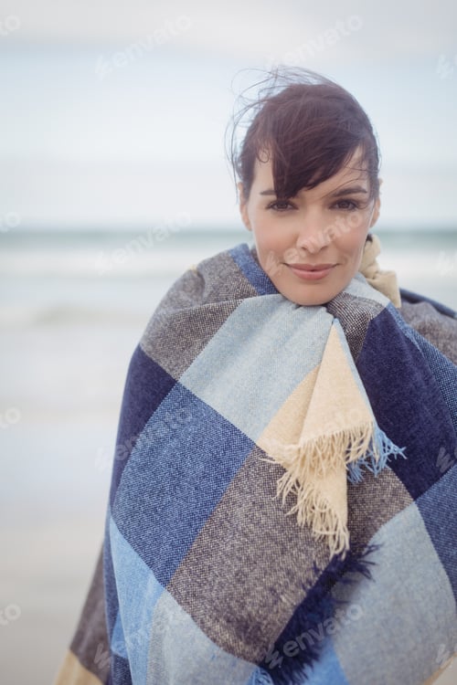 Preview: Portrait of young woman with eays closed wrapped in blanket