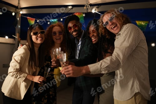 Visualização: Amigos multiétnicos brindando em uma festa na cobertura com óculos de sol coloridos