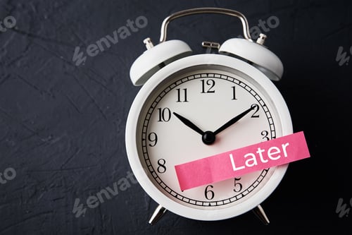 Preview: Procrastination and delay concept. Sticky note with word later on white alarm clock. Urgency time