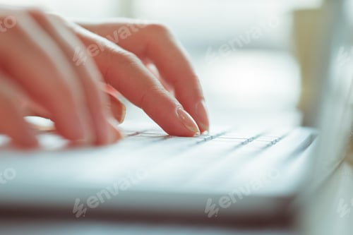 Preview: Hands type on laptop keyboard during work session in bright room