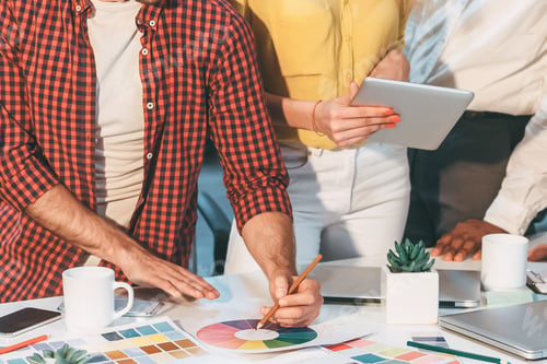 Preview: Group of People Standing Around Table With Tablet