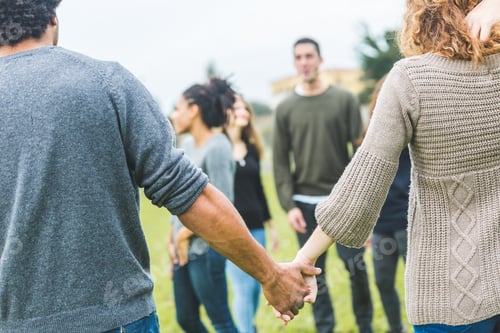 Preview: Multiethnic group of friends holding hands in a circle