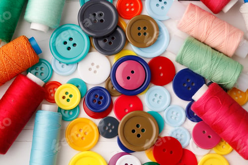 Preview: Colorful sewing accessories on white wooden table