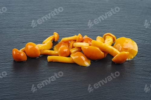 Preview: Marinated honey agarics over black stone slate background