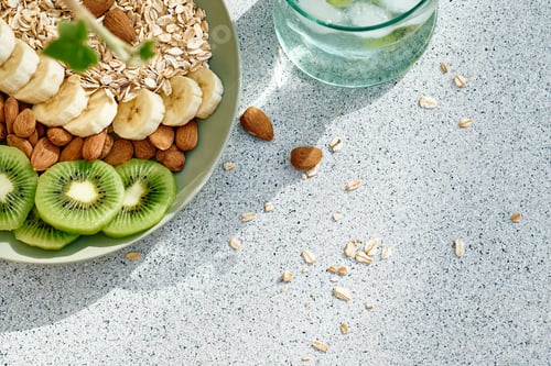 Preview: Healthy Breakfast of tasty granola with kiwi, banana and almond.