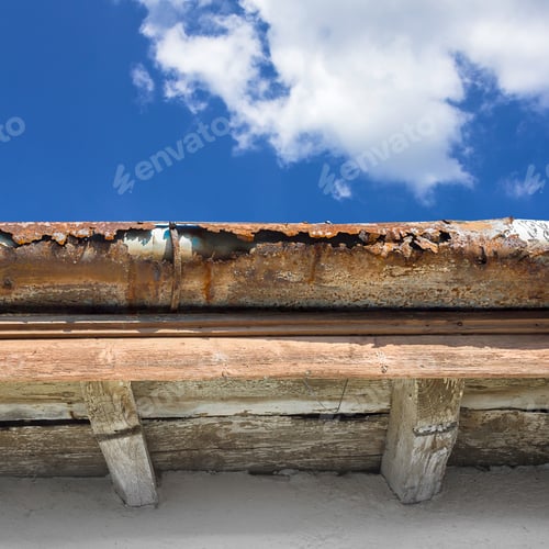 Preview: Old gutter against blue sky