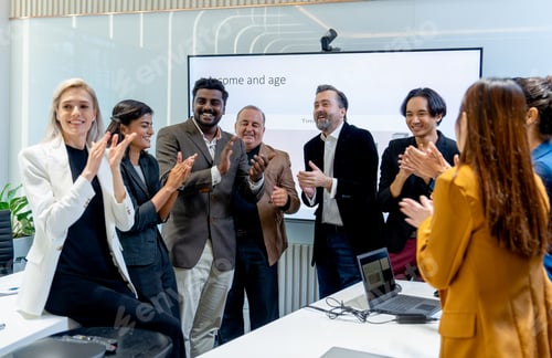 Preview: Crowd of business people stand and crap hands to celebrate the success of project in conference