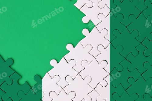 Preview: Nigeria flag is depicted on a completed jigsaw puzzle with free green copy space on the left side.