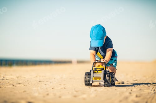 Preview: Toddler boy playing on a sunny beach