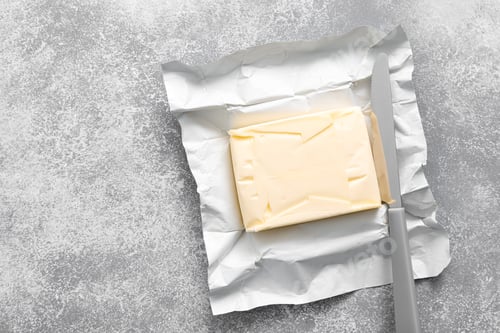 Preview: Block of butter with butter knife in a open pack