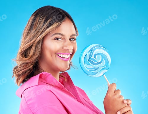 Preview: Woman, lollipop and smile in studio portrait with eating, sweets and excited for food by blue backg
