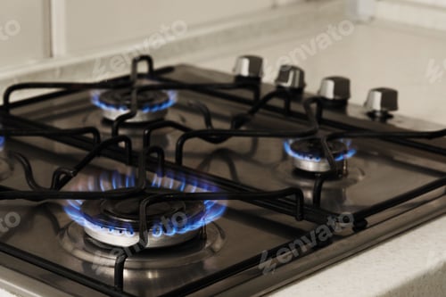 Preview: Gas cooktop with burning blue flames, closeup