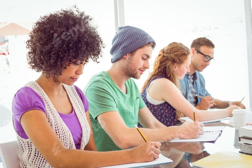 Preview: Fashion students writing on notepad at the college