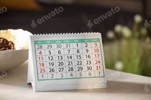 Preview: Paper calendar on light wooden table indoors