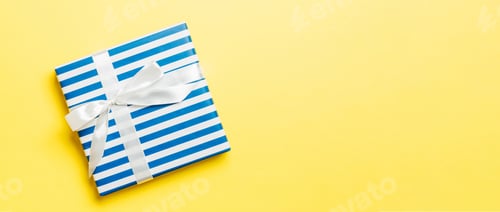 Preview: Top view Christmas present box with white bow on yellow background with copy space
