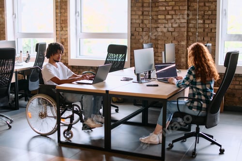 Preview: A diverse group of business professionals collaborates in a modern startup coworking center