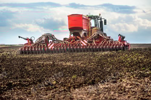 Preview: Farmers sow, using tractor with seeder in a plowed field, apply fertilizer, sowing time