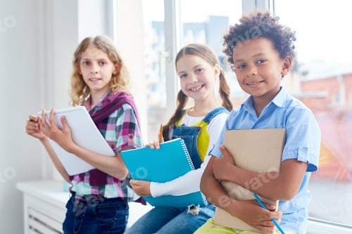 Smiling Students Learning Together in a Bright Classroom