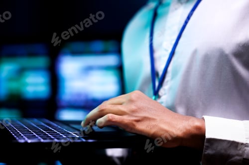 Preview: Expert using laptop to analyze servers