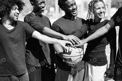 Preview: African friends stacking hands before basketball game outdoor - Focus on hands on ball