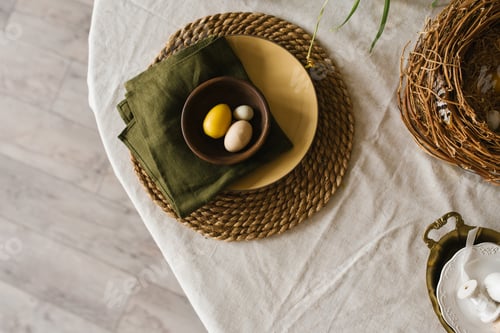 Preview: Table with Green Napkin and a Yellow Plate with Easter Eggs and a Bowl