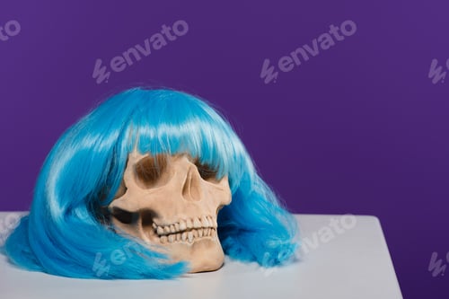 Preview: skull in blue wig on purple background with copy space