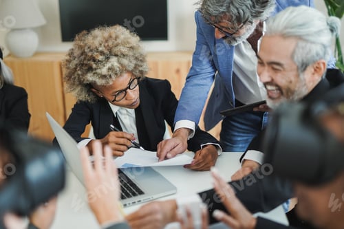 Preview: Multiracial business people working inside modern office while using augmented vr technology