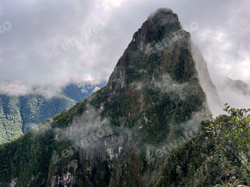 Preview: Landscape of the stunning mountains of Machu Picchu covered in the fog in Peru