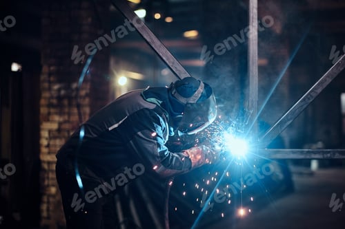 Preview: Man is working at the busy metal factory