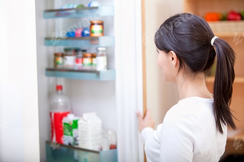 Preview: Woman At Home Looking Inside The Fridge