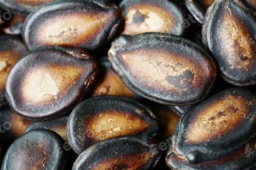 Preview: top view of melon seeds in a bowl on black background