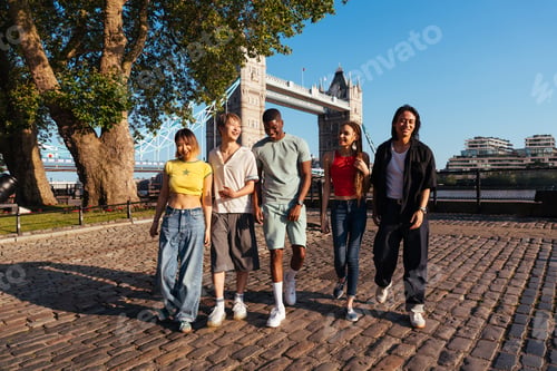 Preview: Multiracial group of happy young friends bonding in London
