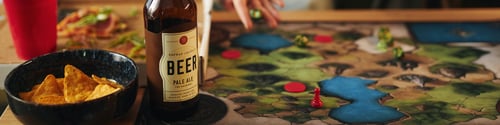 Preview: Playing Board Game with Beer Bottle on Table
