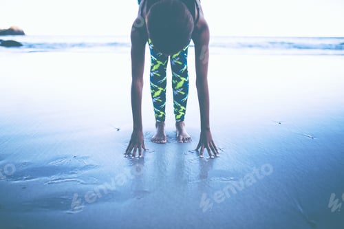 Preview: Young african woman doing morning workout on the beach