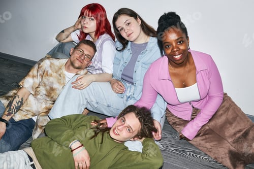 Preview: Smiling Group of Diverse Friends Relaxing on Floor