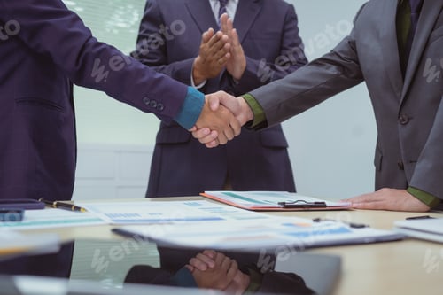 Preview: Close-up of business people shaking hands during meeting in the office,discussing analyzing charts