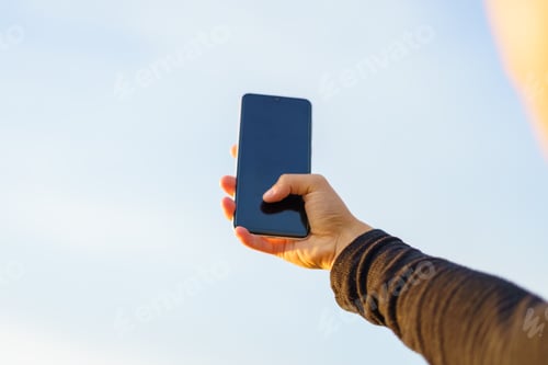 Preview: Unrecognizable young woman taking a selfie with a smartphone