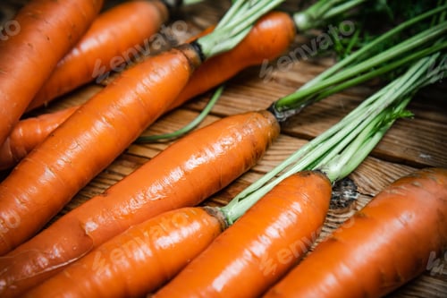 Preview: Fresh carrots on wooden table.
