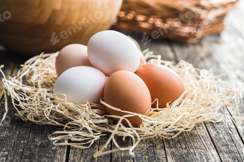 Preview: Whole chicken eggs on wooden table.