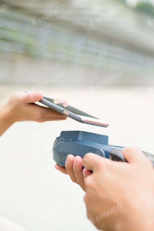 Preview: Customer using mobile phone on pos machine
