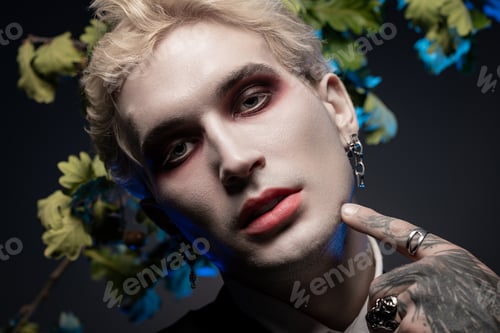 Preview: Young man showcases striking Halloween costume with artistic makeup and bold accessories
